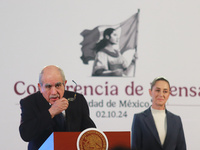 Claudia Sheinbaum Pardo, the first female President of Mexico, stands behind while Pablo Gomez, director of the Financial Intelligence Unit...