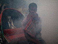 A man suffers in the smoke of mosquito repellent spray in Dhaka, Bangladesh, on October 2, 2024. (