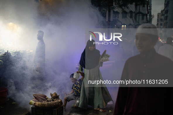 Mosquito repellent is sprayed by a fogger machine to kill mosquitoes as the case of Dengue (spread usually by Aedes mosquito) in Dhaka, Bang...