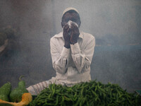 A man suffers in the smoke of mosquito repellent spray in Dhaka, Bangladesh, on October 2, 2024. (