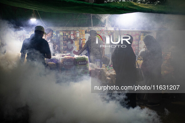 Mosquito repellent is sprayed by a fogger machine to kill mosquitoes as the case of Dengue (spread usually by Aedes mosquito) in Dhaka, Bang...