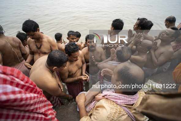 Hindu devotees perform the 'Tarpan' ritual during Mahalaya prayers, also known as Pitru Paksha, at the Brahmaputra river, in Guwahati, India...