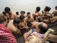 Hindu devotees perform the 'Tarpan' ritual during Mahalaya prayers, also known as Pitru Paksha, at the Brahmaputra river, in Guwahati, India...