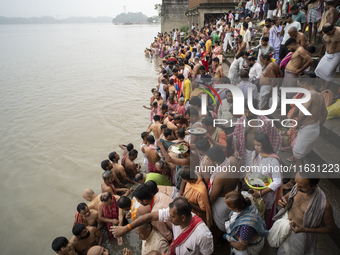 Hindu devotees perform the 'Tarpan' ritual during Mahalaya prayers, also known as Pitru Paksha, at the Brahmaputra river, in Guwahati, India...