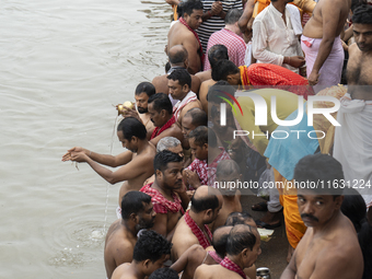 Hindu devotees perform the 'Tarpan' ritual during Mahalaya prayers, also known as Pitru Paksha, at the Brahmaputra river, in Guwahati, India...