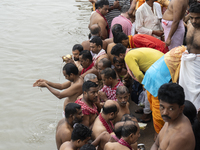 Hindu devotees perform the 'Tarpan' ritual during Mahalaya prayers, also known as Pitru Paksha, at the Brahmaputra river, in Guwahati, India...