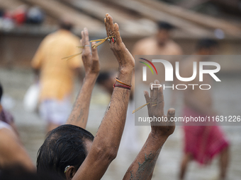 Hindu devotees perform the 'Tarpan' ritual during Mahalaya prayers, also known as Pitru Paksha, at the Brahmaputra river, in Guwahati, India...