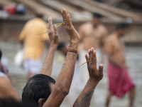 Hindu devotees perform the 'Tarpan' ritual during Mahalaya prayers, also known as Pitru Paksha, at the Brahmaputra river, in Guwahati, India...