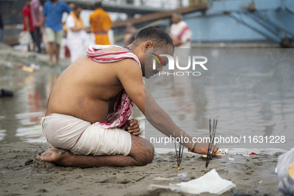 Hindu devotees perform the 'Tarpan' ritual during Mahalaya prayers, also known as Pitru Paksha, at the Brahmaputra river, in Guwahati, India...