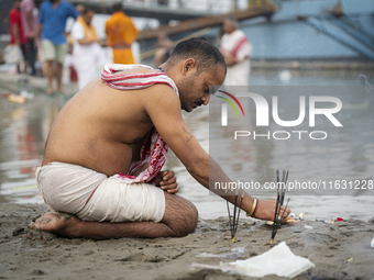 Hindu devotees perform the 'Tarpan' ritual during Mahalaya prayers, also known as Pitru Paksha, at the Brahmaputra river, in Guwahati, India...