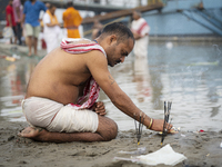 Hindu devotees perform the 'Tarpan' ritual during Mahalaya prayers, also known as Pitru Paksha, at the Brahmaputra river, in Guwahati, India...