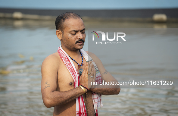 Hindu devotees perform the 'Tarpan' ritual during Mahalaya prayers, also known as Pitru Paksha, at the Brahmaputra river, in Guwahati, India...