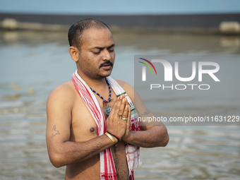 Hindu devotees perform the 'Tarpan' ritual during Mahalaya prayers, also known as Pitru Paksha, at the Brahmaputra river, in Guwahati, India...