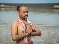 Hindu devotees perform the 'Tarpan' ritual during Mahalaya prayers, also known as Pitru Paksha, at the Brahmaputra river, in Guwahati, India...