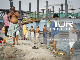 Hindu devotees perform the 'Tarpan' ritual during Mahalaya prayers, also known as Pitru Paksha, at the Brahmaputra river, in Guwahati, India...