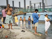 Hindu devotees perform the 'Tarpan' ritual during Mahalaya prayers, also known as Pitru Paksha, at the Brahmaputra river, in Guwahati, India...