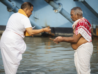 Hindu devotees perform the 'Tarpan' ritual during Mahalaya prayers, also known as Pitru Paksha, at the Brahmaputra river, in Guwahati, India...