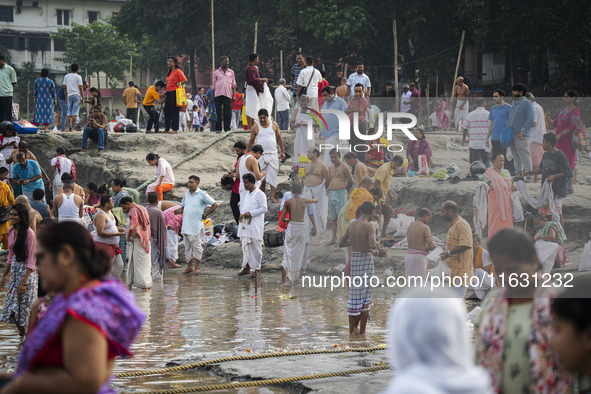 Hindu devotees perform the 'Tarpan' ritual during Mahalaya prayers, also known as Pitru Paksha, at the Brahmaputra river, in Guwahati, India...