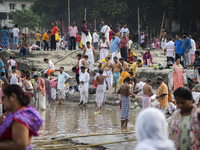 Hindu devotees perform the 'Tarpan' ritual during Mahalaya prayers, also known as Pitru Paksha, at the Brahmaputra river, in Guwahati, India...