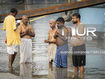 Hindu devotees perform the 'Tarpan' ritual during Mahalaya prayers, also known as Pitru Paksha, at the Brahmaputra river, in Guwahati, India...