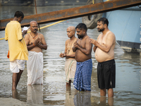 Hindu devotees perform the 'Tarpan' ritual during Mahalaya prayers, also known as Pitru Paksha, at the Brahmaputra river, in Guwahati, India...