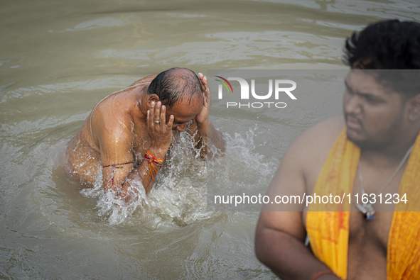 Hindu devotees perform the 'Tarpan' ritual during Mahalaya prayers, also known as Pitru Paksha, at the Brahmaputra river, in Guwahati, India...