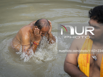 Hindu devotees perform the 'Tarpan' ritual during Mahalaya prayers, also known as Pitru Paksha, at the Brahmaputra river, in Guwahati, India...