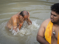 Hindu devotees perform the 'Tarpan' ritual during Mahalaya prayers, also known as Pitru Paksha, at the Brahmaputra river, in Guwahati, India...