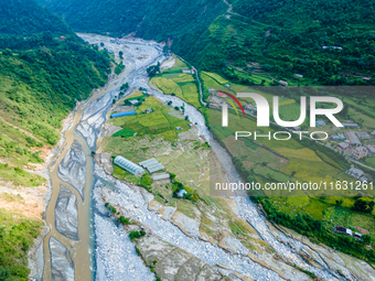 The aerial view shows the flood-affected areas of the Kulekhani River in the Sisneri region of Makwanpur, Nepal, on October 2, 2024. Thirty-...