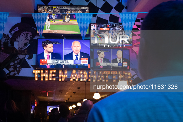 People watch the vice presidential debate between Demcocrat Gov. Tim Walz (D-MN) and Republican Sen. J.D. Vance (R-OH) at Madhatter in Washi...