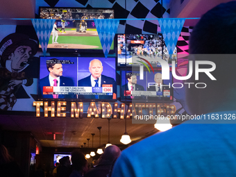 People watch the vice presidential debate between Demcocrat Gov. Tim Walz (D-MN) and Republican Sen. J.D. Vance (R-OH) at Madhatter in Washi...