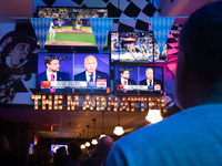 People watch the vice presidential debate between Demcocrat Gov. Tim Walz (D-MN) and Republican Sen. J.D. Vance (R-OH) at Madhatter in Washi...