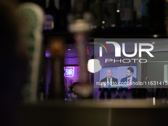 A mirror behind the bar reflects the vice presidential debate between Demcocrat Gov. Tim Walz (D-MN) and Republican Sen. J.D. Vance (R-OH) a...