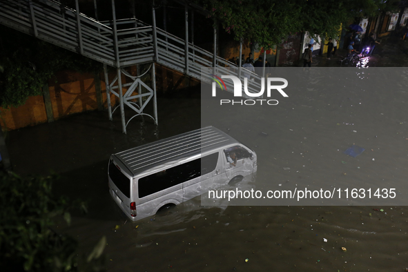 A vehicle is stuck on a waterlogged street following heavy rainfall in Dhaka, Bangladesh, on October 2, 2024. Several roads in the capital c...