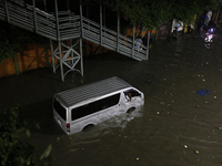 A vehicle is stuck on a waterlogged street following heavy rainfall in Dhaka, Bangladesh, on October 2, 2024. Several roads in the capital c...