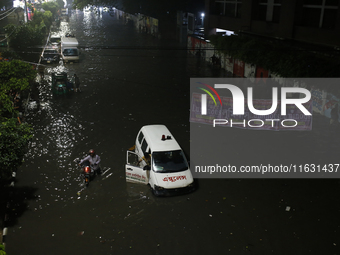 An ambulance is stuck on a waterlogged street following heavy rainfall in Dhaka, Bangladesh, on October 2, 2024. Several roads in the capita...