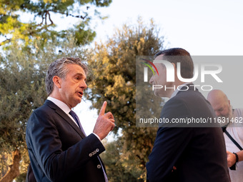 Stephen Dunbar-Johnson, the president of International of The New York Times Company, and Haris Doukas, the Mayor of Athens, participate in...