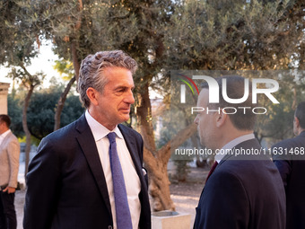 Stephen Dunbar-Johnson, the president of International of The New York Times Company, and Haris Doukas, the Mayor of Athens, participate in...