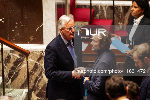 In Paris, France, on October 2, 2024, French Prime Minister Michel Barnier shakes hands with Boris Vallaud, President of the Socialistes et...