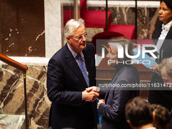 In Paris, France, on October 2, 2024, French Prime Minister Michel Barnier shakes hands with Boris Vallaud, President of the Socialistes et...