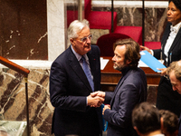 In Paris, France, on October 2, 2024, French Prime Minister Michel Barnier shakes hands with Boris Vallaud, President of the Socialistes et...