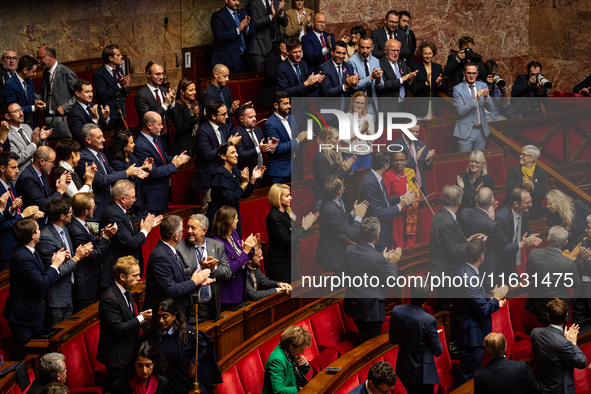 In Paris, France, on October 2, 2024, deputies of the French far-right group Rassemblement National applaud the intervention of the group's...