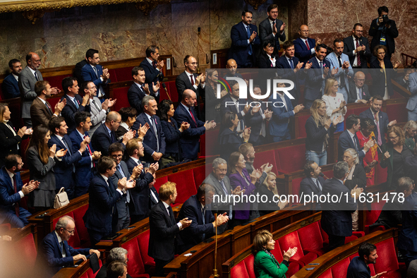 In Paris, France, on October 2, 2024, deputies of the French far-right group Rassemblement National applaud the intervention of the group's...