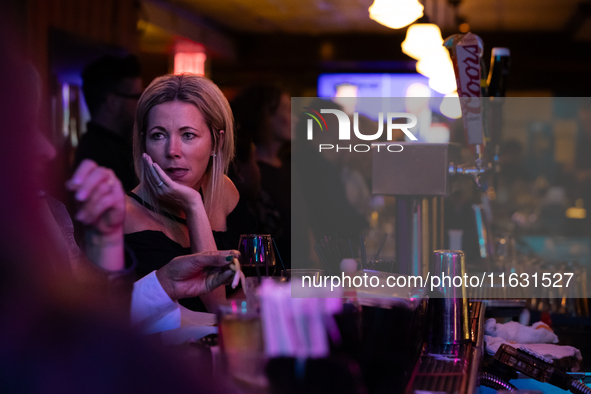 People attend a watch party at Madhatter for the vice presidential debate between Demcocrat Gov. Tim Walz (D-MN) and Republican Sen. J.D. Va...