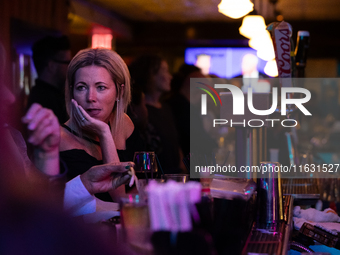 People attend a watch party at Madhatter for the vice presidential debate between Demcocrat Gov. Tim Walz (D-MN) and Republican Sen. J.D. Va...