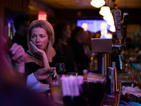 People attend a watch party at Madhatter for the vice presidential debate between Demcocrat Gov. Tim Walz (D-MN) and Republican Sen. J.D. Va...