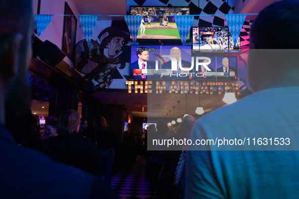 People watch the vice presidential debate between Demcocrat Gov. Tim Walz (D-MN) and Republican Sen. J.D. Vance (R-OH) at Madhatter in Washi...