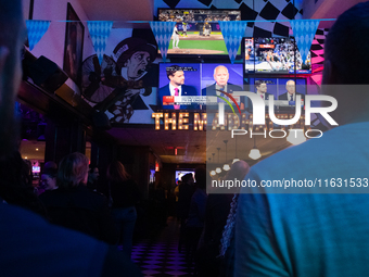 People watch the vice presidential debate between Demcocrat Gov. Tim Walz (D-MN) and Republican Sen. J.D. Vance (R-OH) at Madhatter in Washi...