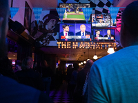 People watch the vice presidential debate between Demcocrat Gov. Tim Walz (D-MN) and Republican Sen. J.D. Vance (R-OH) at Madhatter in Washi...