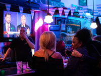 People attend a watch party at Madhatter for the vice presidential debate between Demcocrat Gov. Tim Walz (D-MN) and Republican Sen. J.D. Va...